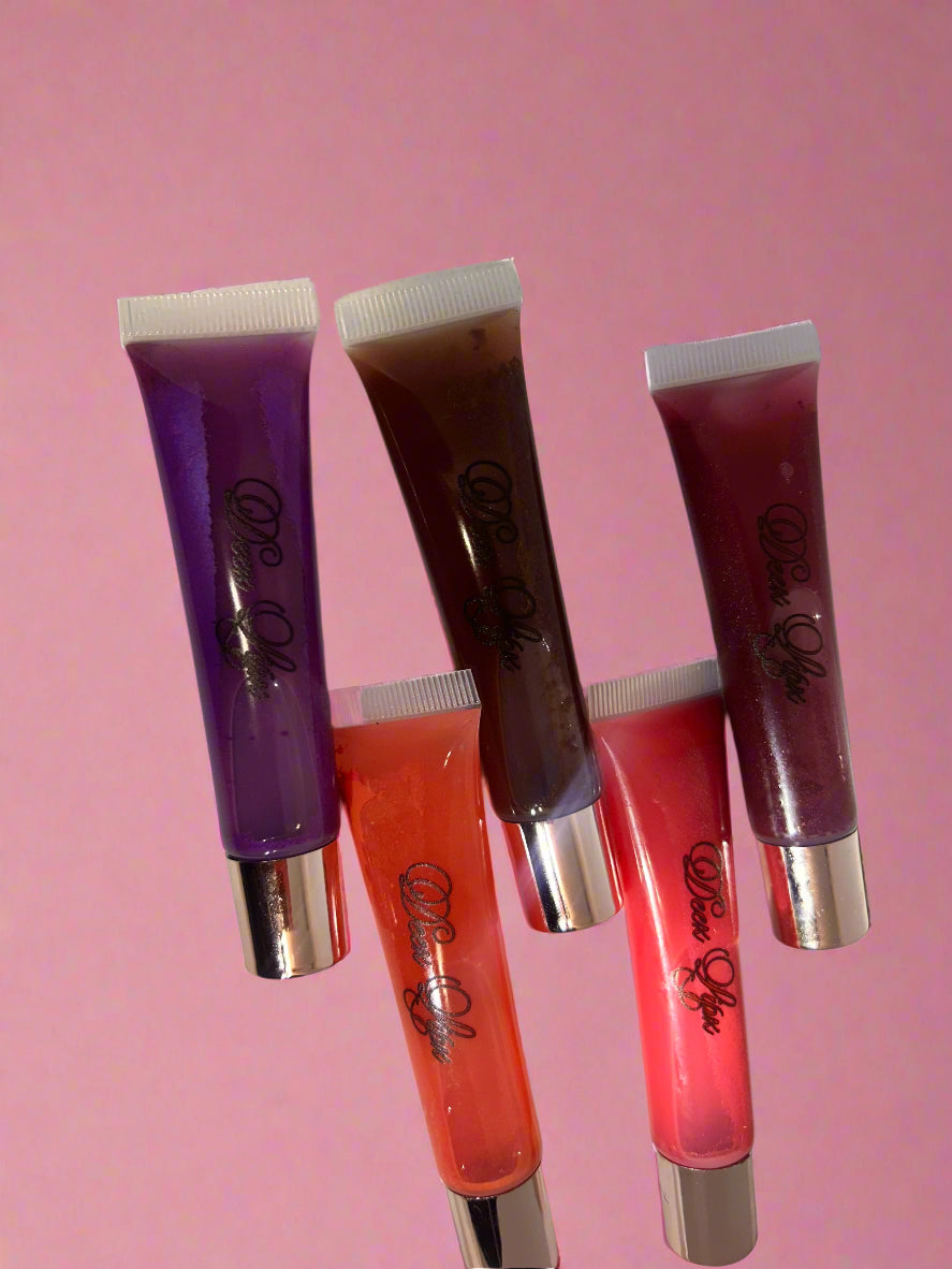 Five lip gloss tubes in different colors on a white background
