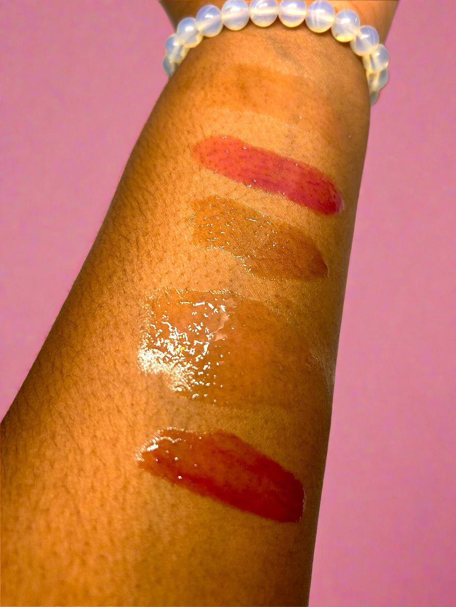 Lipstick swatches on a person's arm with a white background
