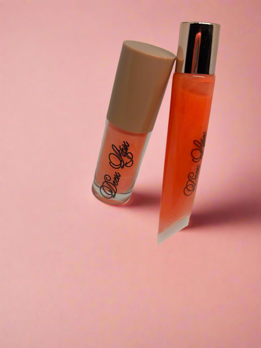 Two lip glosses, one orange and one beige, on a white background